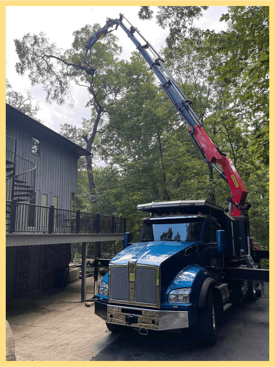 Crane Lifting Limb Above House